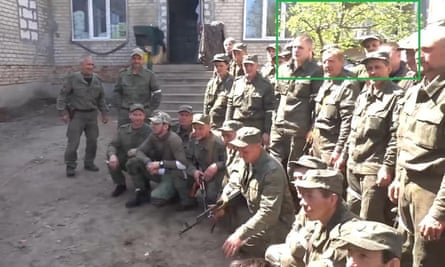 A screengrab of footage of soldiers from the Luhansk People's Republic outside Izium's school number six.