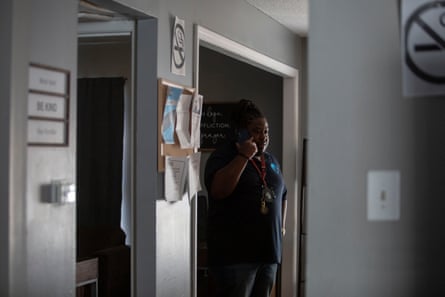 A man speaks on a phone in an office