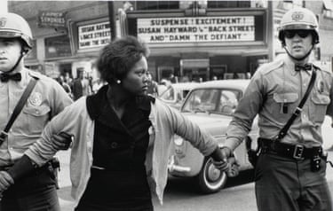 police officer holding the hands of a woman