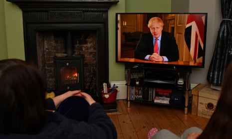 A family watch the prime minister's address on Monday evening.