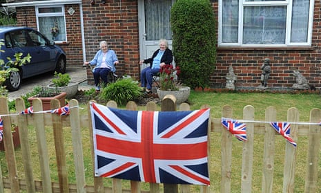 Old people in a garden with union jacks