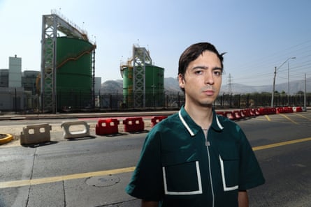 Rodrigo Vallejos stands on a road with a datacentre behind him.