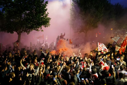 Arsenal fans celebrate the title outside the Emirates on 19 May.