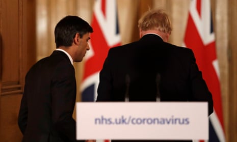 The chancellor, Rishi Sunak, leaves the coronavirus press conference with Boris Johnson.