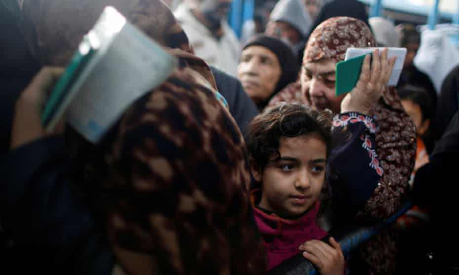Palestinian refugees wait to receive aid at a UN food distribution center in Al-Shati refugee camp in Gaza City on 15 January 2018.