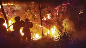 Firefighters battle to contain a forest fire