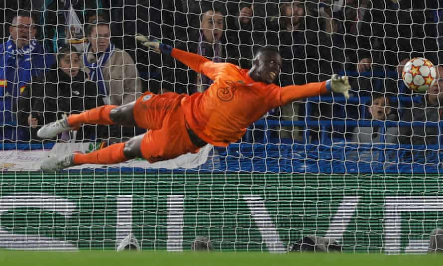 Chelsea’s French-born Senegalese goalkeeper Edouard Mendy dives but cannot reach a second goal-bound header from Real Madrid’s French striker Karim Benzema.