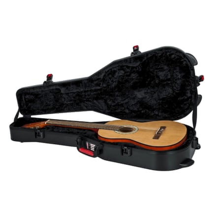 Open black guitar case with acoustic guitar inside