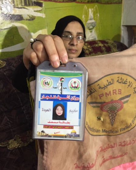 Sabrine al-Najjar holds up her daughter’s identity card