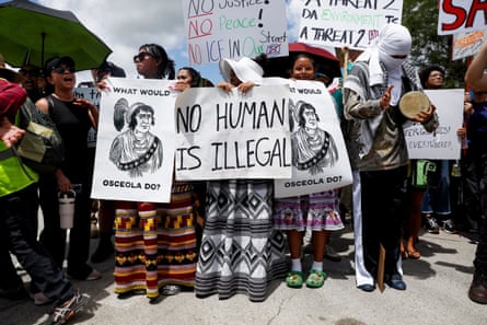a group of protesters hold placards