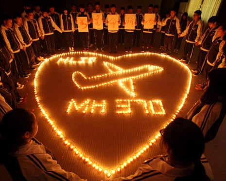 Students in China’s Zhejiang province lighting candles for passengers on missing Malaysia Airlines flight MH370 in the shape of a heart