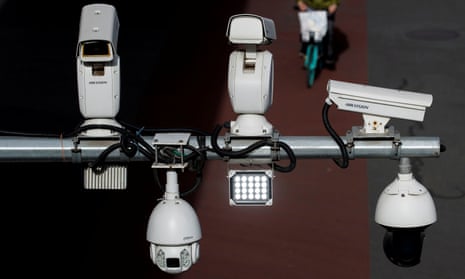 Hikvision and Dahua CCTV security surveillance cameras overlook a street