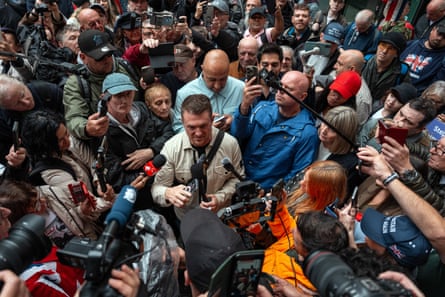 Tommy Robinson surrounded by people and cameras