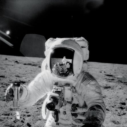 Alan Bean holds a container filled with lunar soil in a picture taken by Pete Conrad.