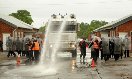 Officers training with a water cannon.