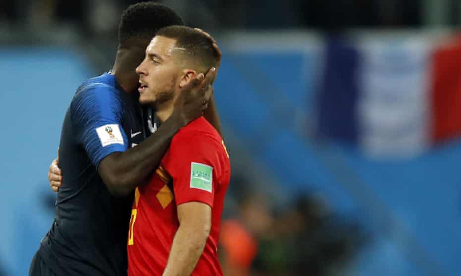 Belgium’s Eden Hazard is consoled by France’s Samuel Umtiti after the final whistle.