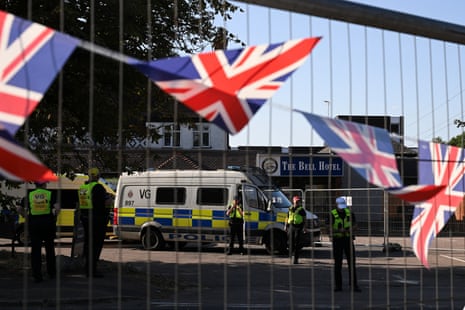 Government looking at contingency options for where to house asylum seekers after Epping court ruling – UK politics live | UK news 2 Police officers guard the entrance of the Bell hotel in Epping during a demonstration earlier this month.