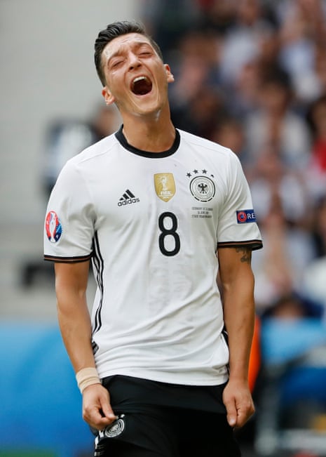 Ozil reacts after missing a chance.