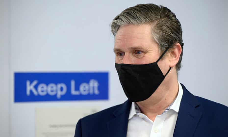 Keir Starmer speaks with medical staff during a visit to the Whittington Hospital in London