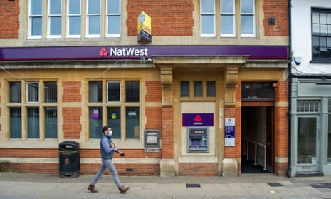 A branch of NatWest with someone walking by