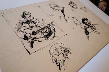 Sketches of men’s heads and a man playing the guitar on a single sheet of paper