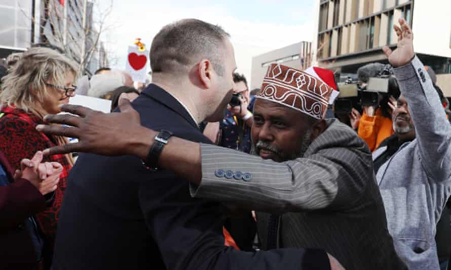 Mohamed Jama, Muslim Association Canterbury, celebrates with members of the public after the judgement and the last day of the sentencing for Australian white supremacist Brenton Tarrant in Christchurch on August 27, 2020.