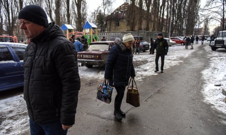 Local residents walk past a building destroyed by a Russian drone attack in Kyiv, Ukraine.