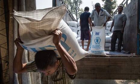 A worker carries a sack filled with rice in the Beldangi 2 refugee camp in Nepal. 