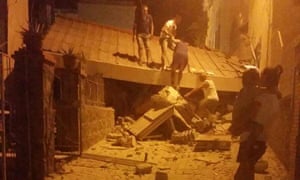 People remove debris after an earthquake hit Ischia island, near Naples, Southern Italy.