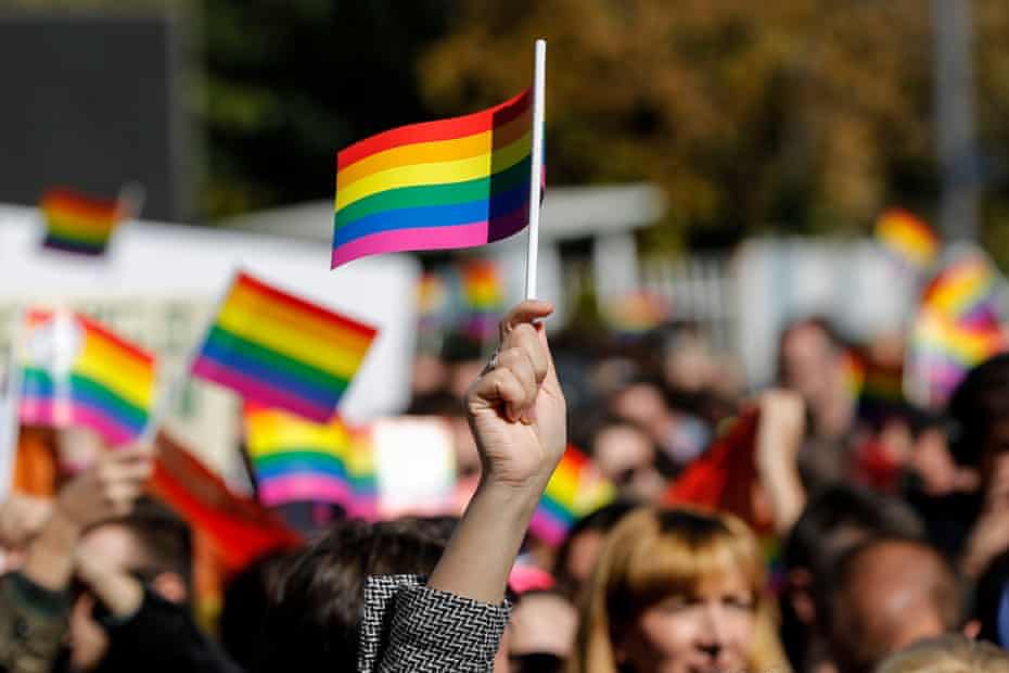 Participants wave rainbow flags at an LGBT rights groups parade