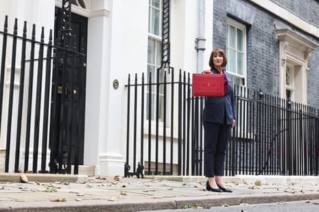 Britain’s Chancellor of the Exchequer Rachel Reeves stands with the red Budget Box in an outstretched hand outside 11 Downing Street