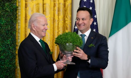 President Joe Biden and Ireland’s taoiseach, Leo Varadkar, hold a bowl of shamrocks during a St Patrick’s Day reception in the East Room of the White House.