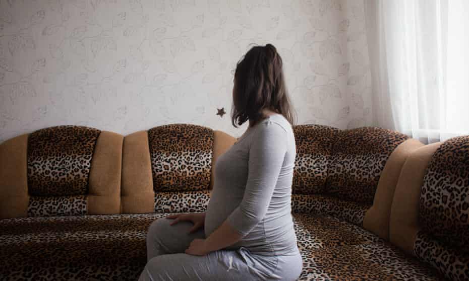Olga who is on her second surrogate pregnancy, twins for a Chinese couple, waits in a rented apartment in Kyiv
