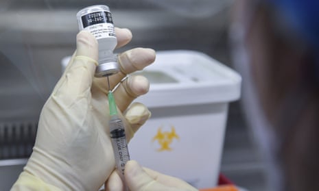 A nurse fills a syringe with the Pfizer/BioNTech Covid-19 vaccine at a vaccination centre in Seoul