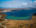 Aerial view of Stanley, Falkland Islands, beside a bay with a shipwreck in turquoise shallows