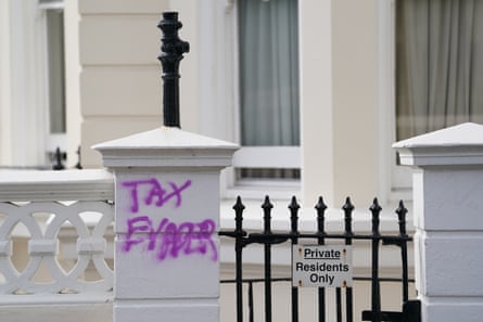 Purple graffiti reading ‘Tax evader’