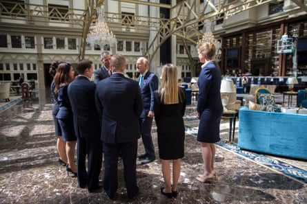 Staff members meet in the lobby of the Trump International Hotel just after it opened.