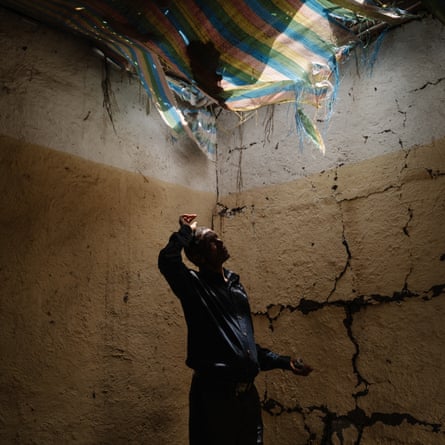 A man stands inside a building with a town roof