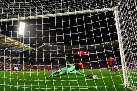 Senne Lammens of Belgium fails to save a shot form Michael Olise of France.