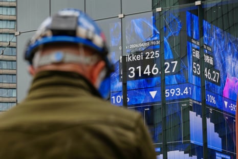 A person stands in front of an electronic stock board showing Japan's Nikkei index on Thursday.