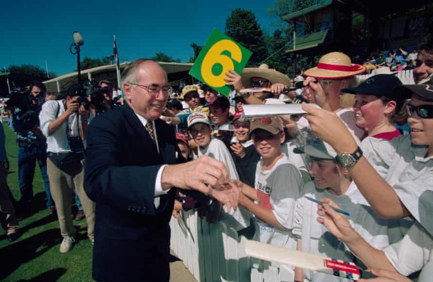 John Howard greets schoolchildren during a match between the Prime Minister’s XI Australian team and the West Indies in 1996