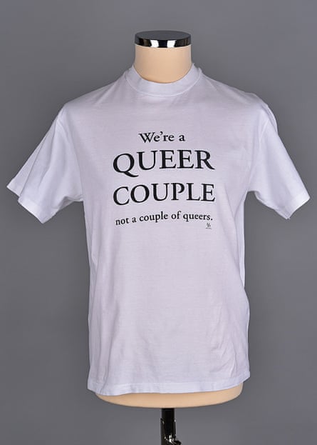 shirt says “We’re a queer couple not a couple of queers.”