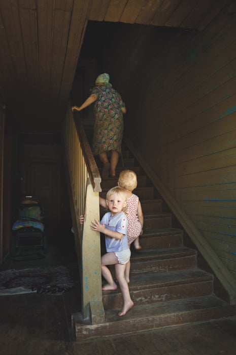 Nadia Sablin’s portrait of two young children following their grandmother up a wooden staircase, taken in 2009.