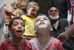 Syrian boys cry following Russian air strikes on the rebel-held Fardous neighbourhood of the northern embattled Syrian city of Aleppo
