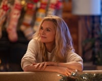 Michelle Pfeiffer in front of Christmas stockings.