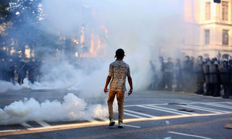 A protester stands amidst tear gas during a protest in Atlanta against the death of George Floyd.