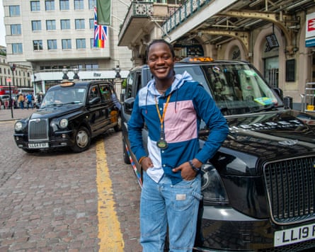 Bahrain rests on his black cab as he waits for a fare outside Charing Cross station