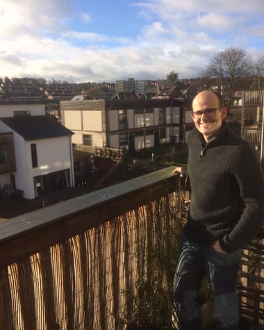 Max Folkett on the balcony of his two-bed flat at Lilac in Leeds.