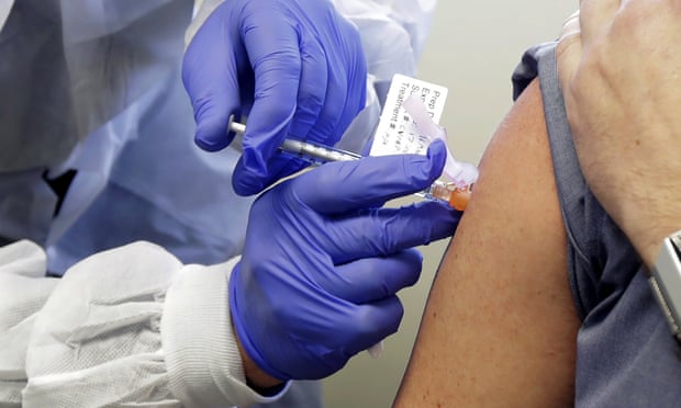 A participant gets his injection in the first-phase trial of the coronavirus vaccine developed by Moderna, a company based in Cambridge, Massachusetts.