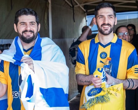 Smiling Ziv and Gali Berman in Maccabi Tel Aviv shirts, Ziv is draped in an Israeli flag